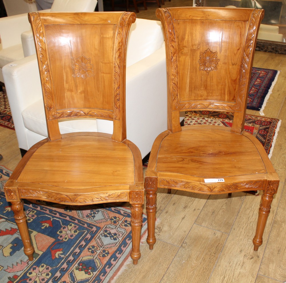 A pair of Asian hardwood hall chairs, with foliate carved frames, W.57cm D.52cm H.115cm